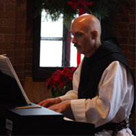 Father Emmanuel at the piano.